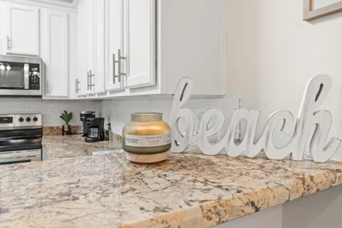 a dining room with stainless steel appliances furniture a window and a kitchen view