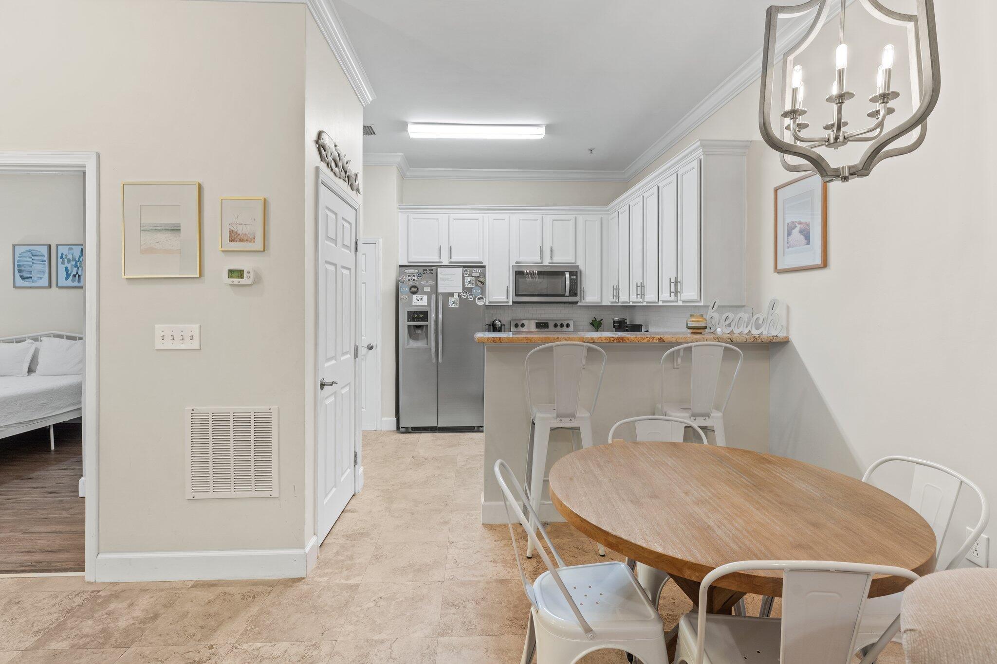 231 Somerset Bridge Road, Unit 1110 Santa Rosa Beach, FL 32459 - Photo 15 of 51 a dining room with stainless steel appliances furniture a window and a kitchen view