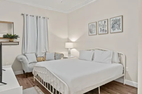 a bedroom with a bed and a night stand