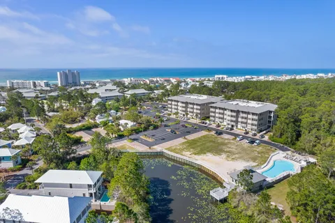 an aerial view of residential house with outdoor space and trees all around