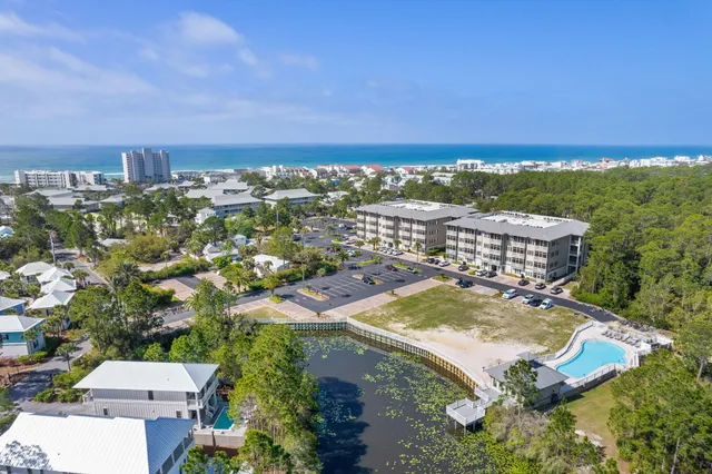 an aerial view of residential house with outdoor space and trees all around