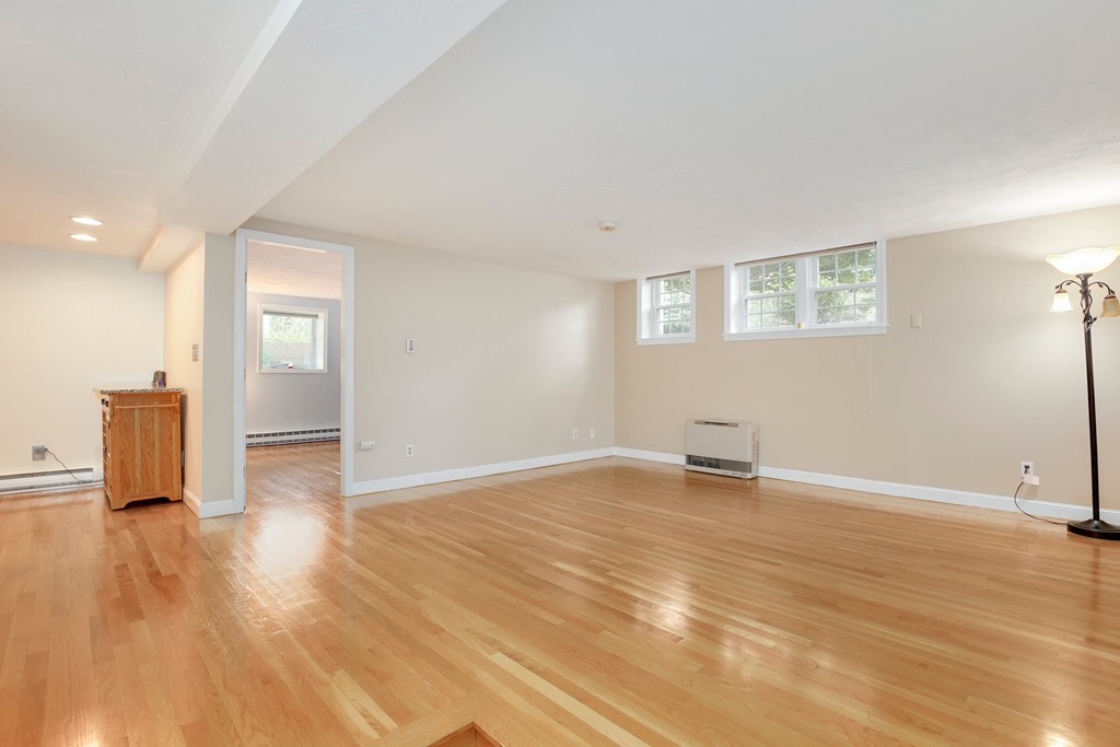 5 Porter Road, Unit A2 Andover, MA 01810 - Photo 6 of 22 a view of an empty room with wooden floor and a window