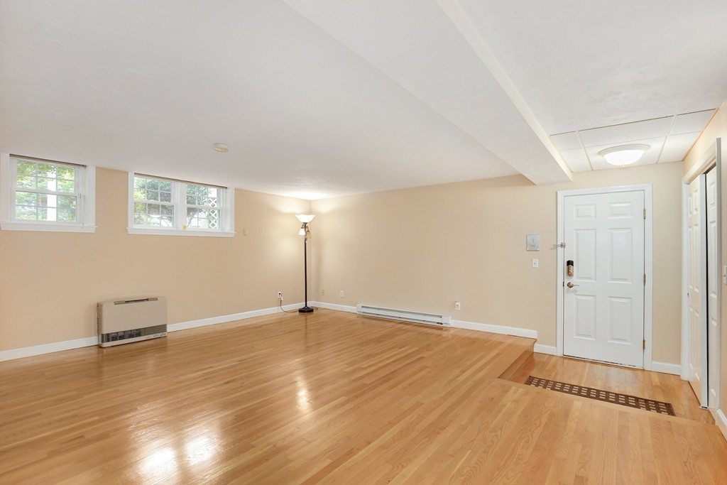 5 Porter Road, Unit A2 Andover, MA 01810 - Photo 8 of 22 an empty room with wooden floor and windows