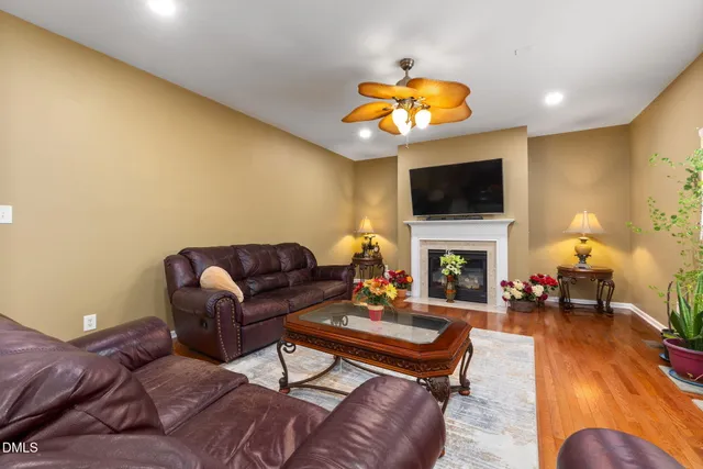 a living room with furniture a fireplace and a flat screen tv
