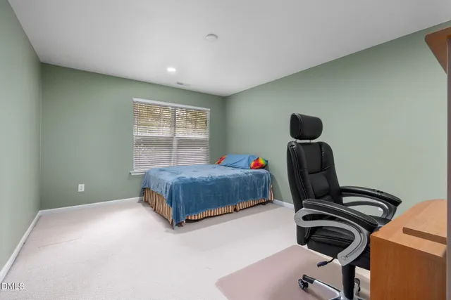 a bedroom with a bed and a desk