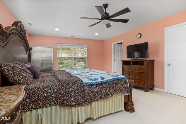a bedroom with a bed and flat screen tv