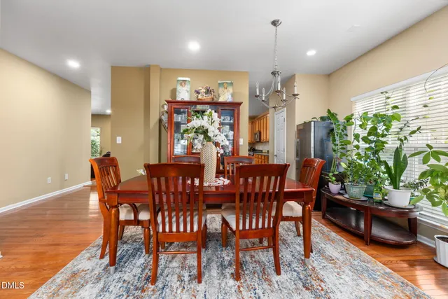 a view of a dining room with furniture and a potted plant