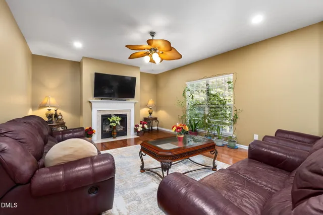 a living room with furniture a fireplace and a flat screen tv