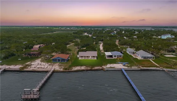an aerial view of residential houses with outdoor space and street view