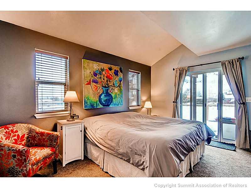 820 Alpine Road Dillon, CO 80435 - Photo 13 of 25 a bedroom with a bed and a flat screen tv