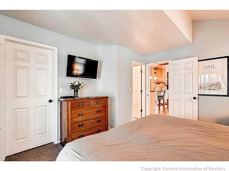 820 Alpine Road Dillon, CO 80435 - Photo 15 of 25 a bedroom with a bed and a flat screen tv
