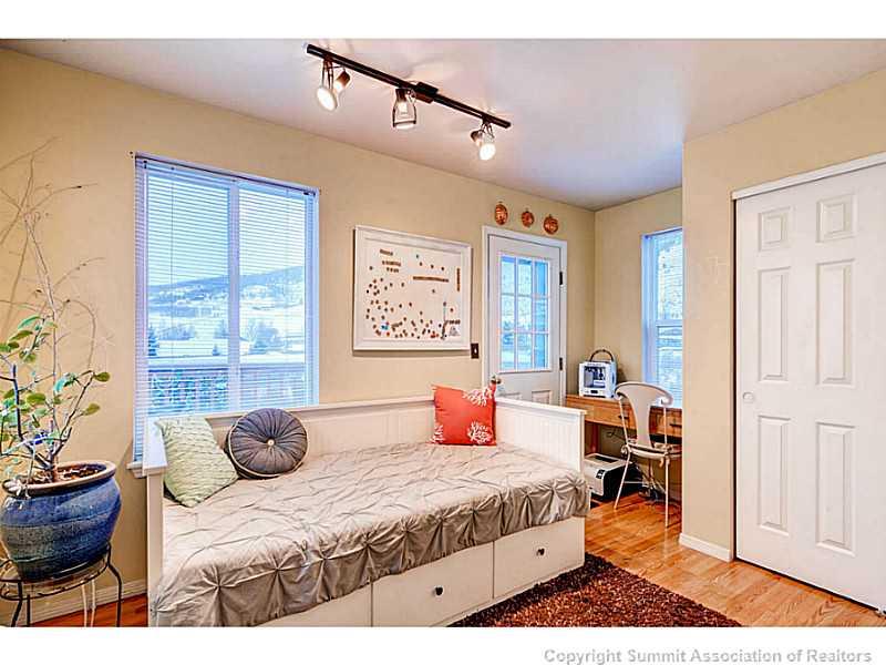 820 Alpine Road Dillon, CO 80435 - Photo 21 of 25 a bedroom with a bed and wooden floor