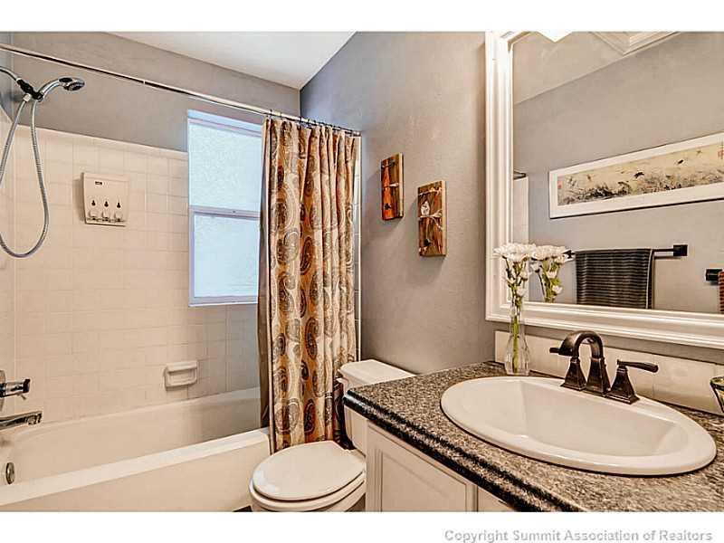 820 Alpine Road Dillon, CO 80435 - Photo 23 of 25 a bathroom with a granite countertop sink and a mirror