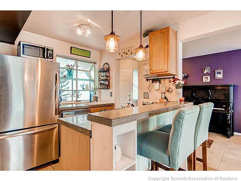 820 Alpine Road Dillon, CO 80435 - Photo 9 of 25 a kitchen with stainless steel appliances a refrigerator and a table