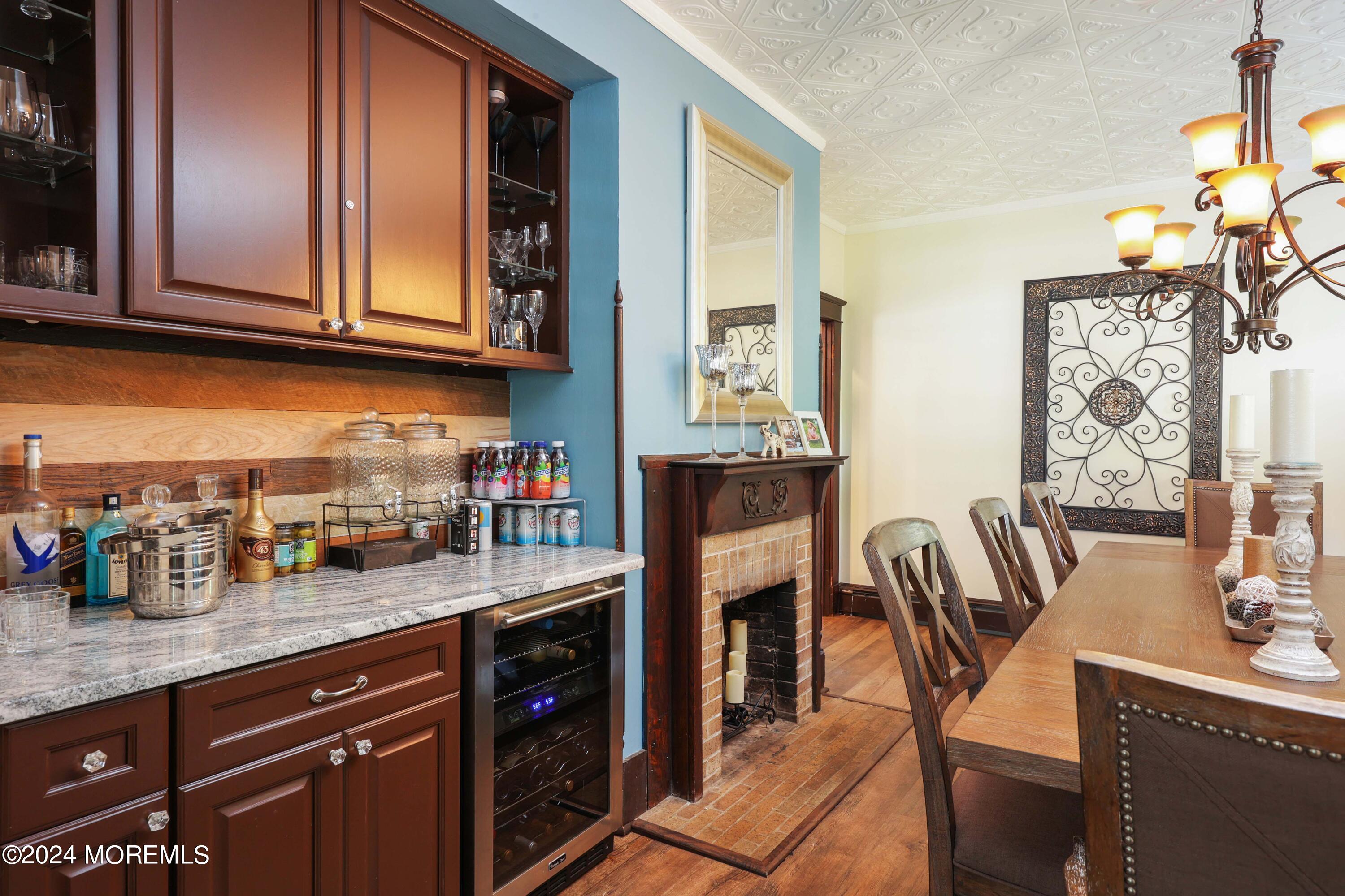 1158 West Front Street Lincroft, NJ 07738 - Photo 11 of 33 a kitchen with granite countertop a table chairs sink and cabinets