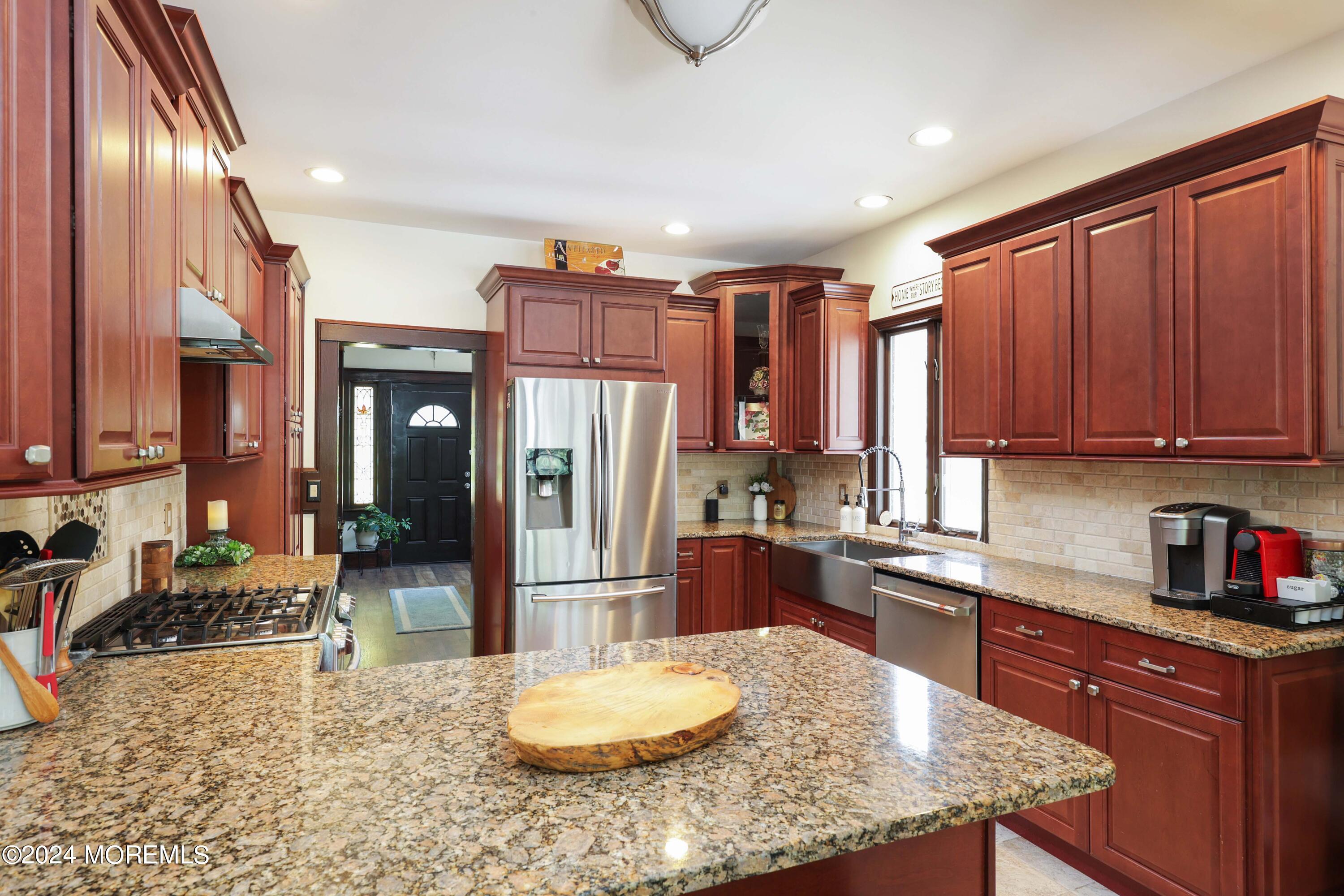 1158 West Front Street Lincroft, NJ 07738 - Photo 13 of 33 a kitchen with stainless steel appliances granite countertop a refrigerator a stove and a sink with wooden cabinets
