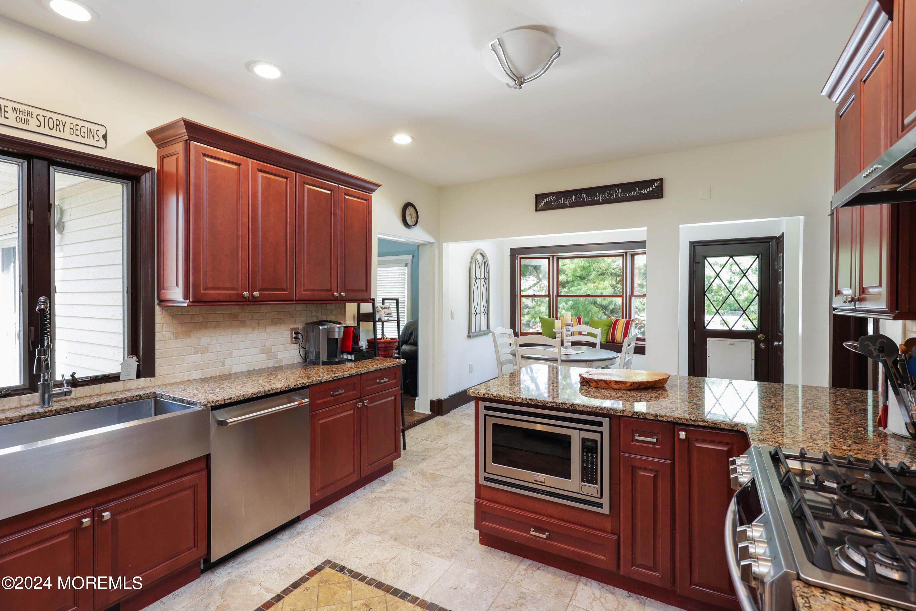 1158 West Front Street Lincroft, NJ 07738 - Photo 14 of 33 a kitchen with stainless steel appliances granite countertop a stove a sink and a microwave
