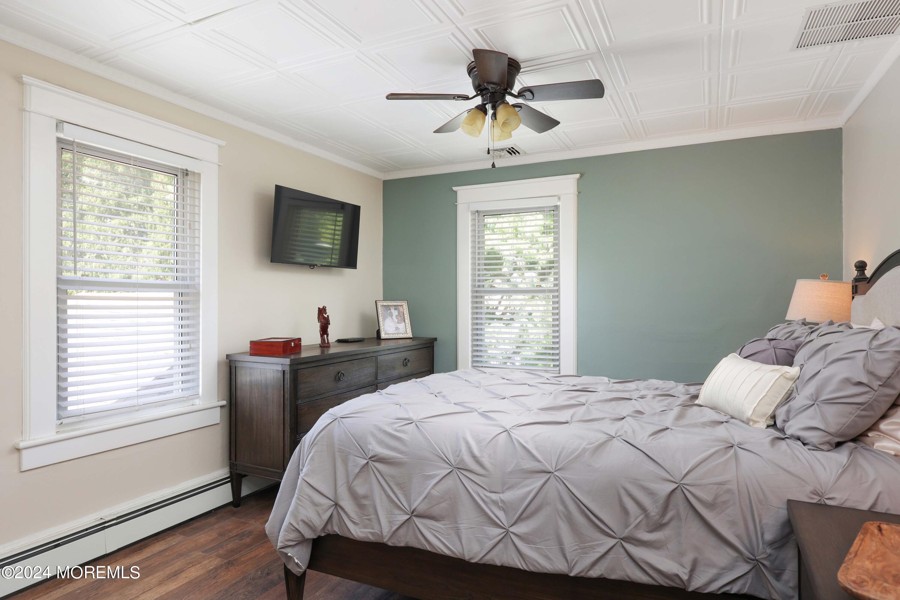 1158 West Front Street Lincroft, NJ 07738 - Photo 18 of 33 a bedroom with a bed and a flat screen tv