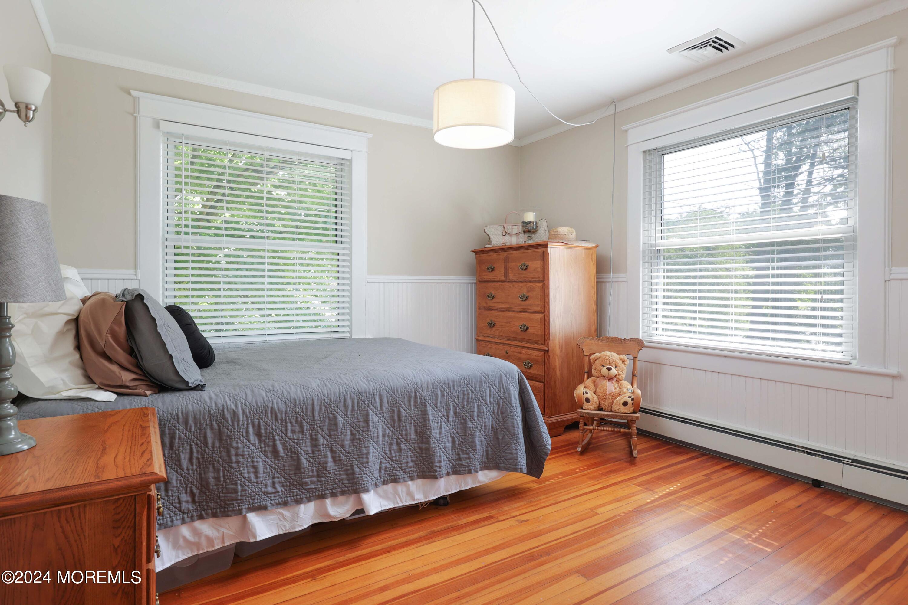 1158 West Front Street Lincroft, NJ 07738 - Photo 20 of 33 a bedroom with a bed and wooden floor