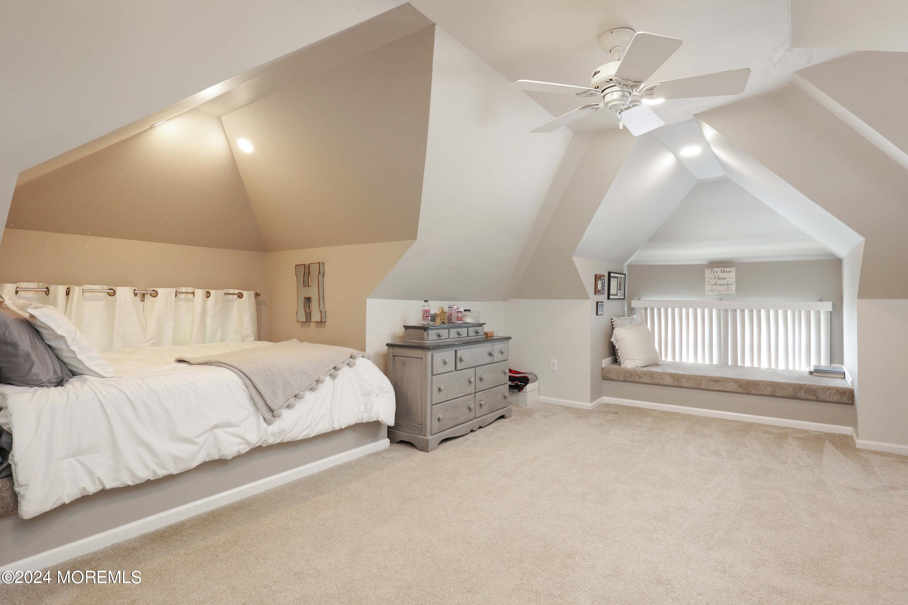 1158 West Front Street Lincroft, NJ 07738 - Photo 23 of 33 a spacious bedroom with a bed and a chandelier