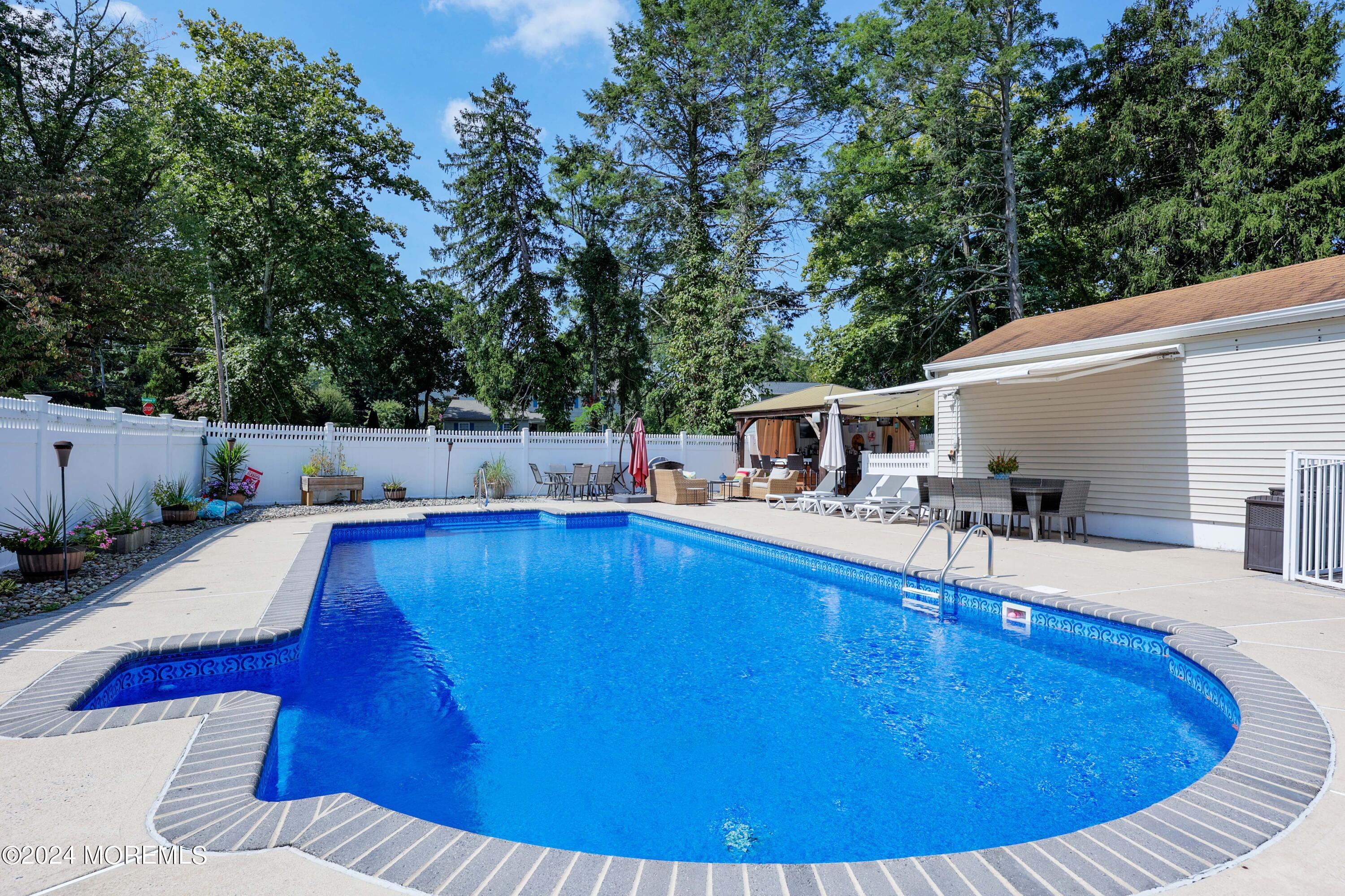 1158 West Front Street Lincroft, NJ 07738 - Photo 26 of 33 a view of a swimming pool with a patio