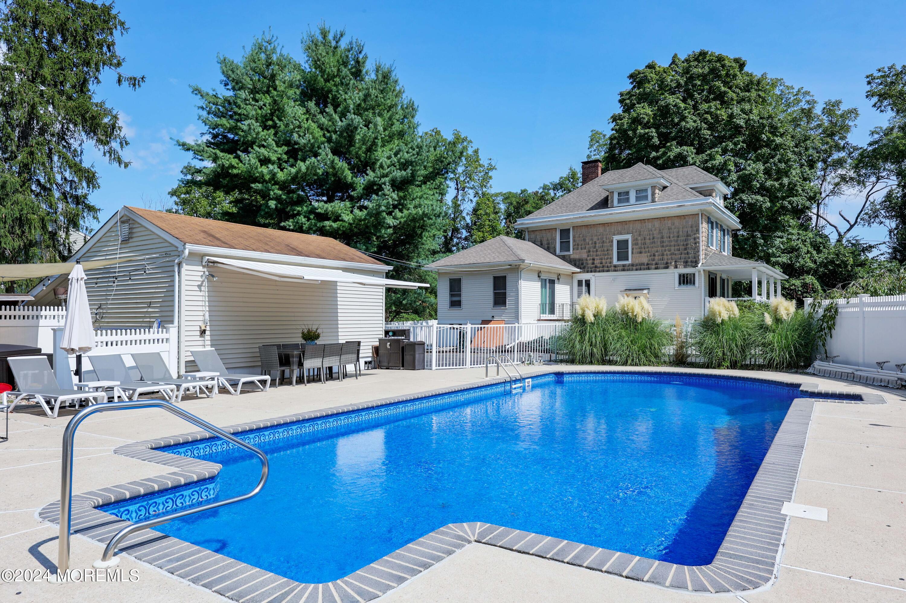 1158 West Front Street Lincroft, NJ 07738 - Photo 3 of 33 a view of swimming pool with outdoor seating and house in the background