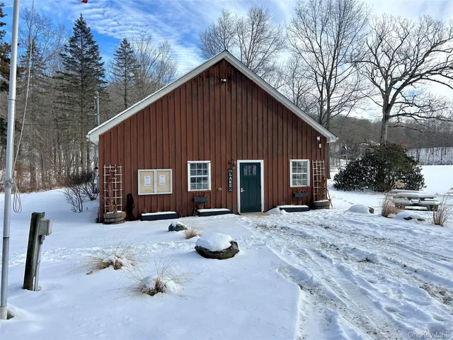 a street view with couple of cars parked in front of house