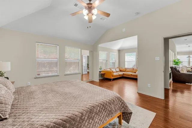 a bedroom with a bed couch and a large window