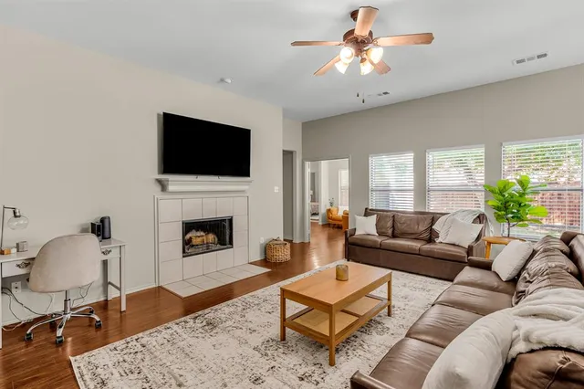 a living room with furniture a fireplace and a flat screen tv