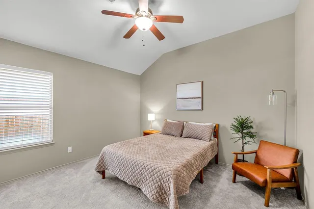 a bedroom with a bed and chair