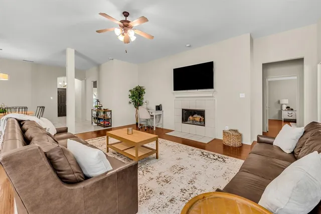 a living room with furniture fireplace and a flat screen tv