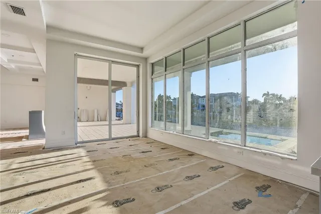a bedroom with a large window and a bath tub