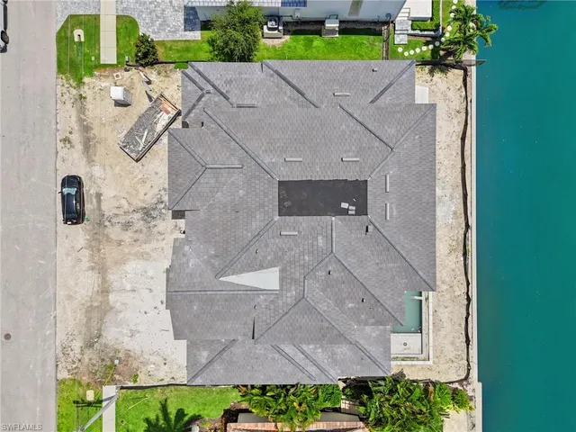 a front view of a house with a small yard and potted plants