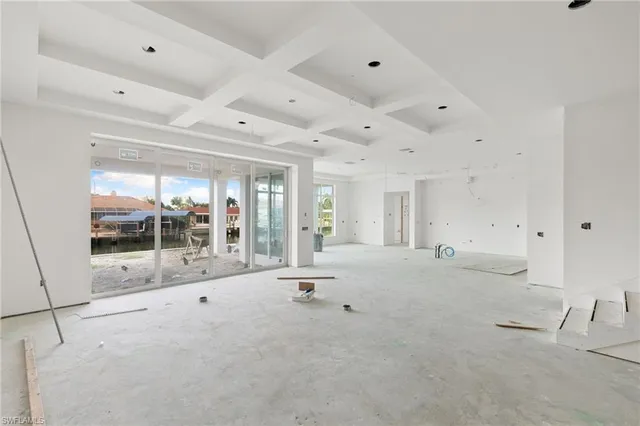 a dining room with furniture a chandelier and fireplace