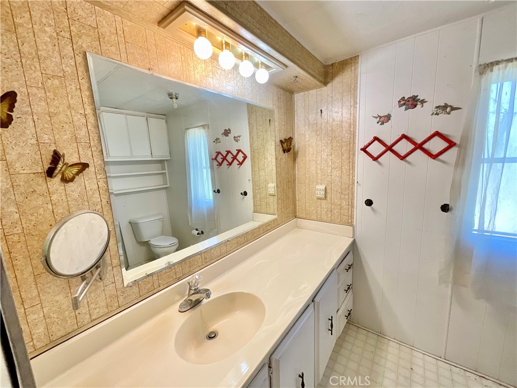 7282 Marin Street Nice, CA 95464 - Photo 53 of 69 a bathroom with a granite countertop sink and a mirror