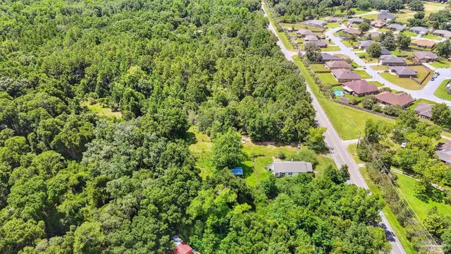 a backyard of a house with lots of green space and garden in the back