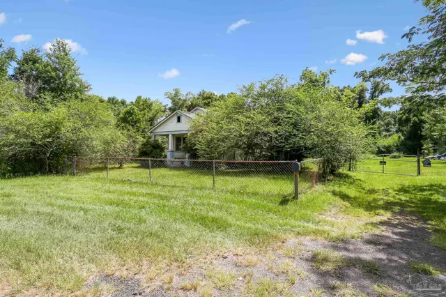 a view of a yard with a house in the background