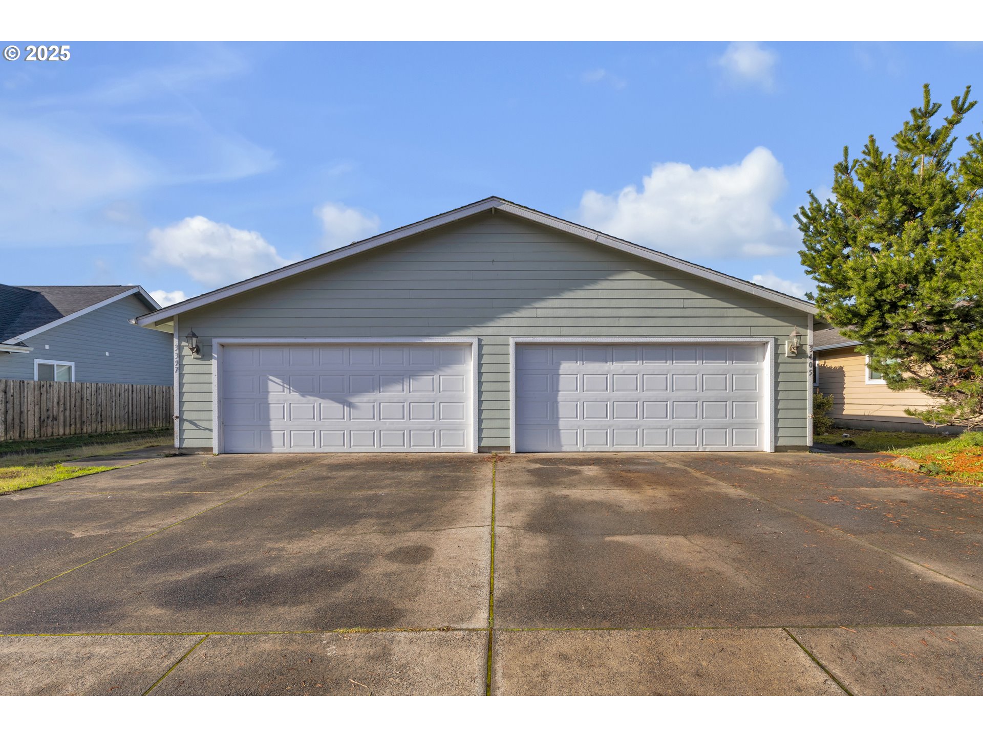 3397 Oak Street Florence, OR 97439 - Photo 1 of 48 a view of a house with a yard and garage
