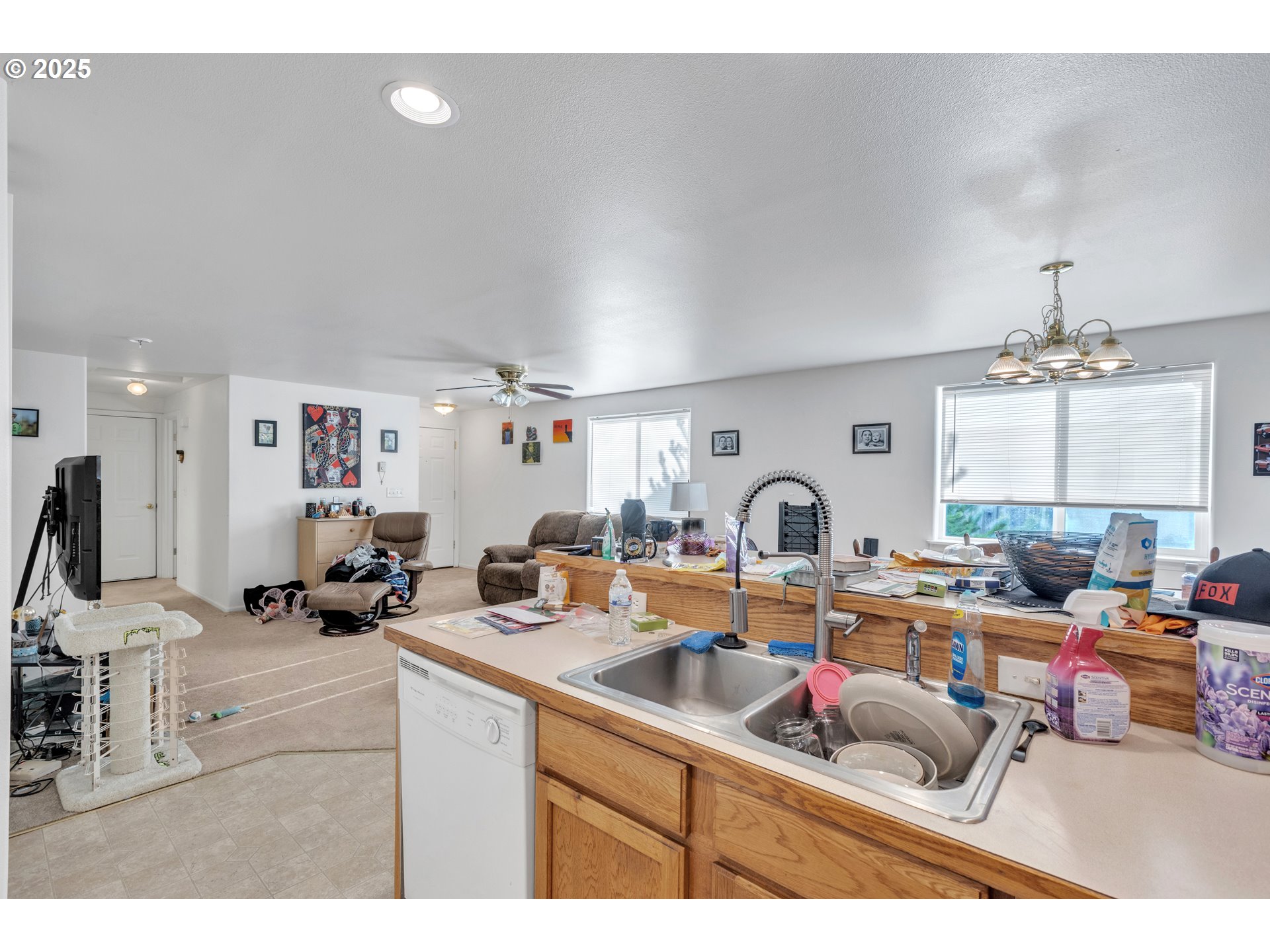 3397 Oak Street Florence, OR 97439 - Photo 12 of 48 a kitchen with a sink dishwasher a dining table and chairs with a large mirror