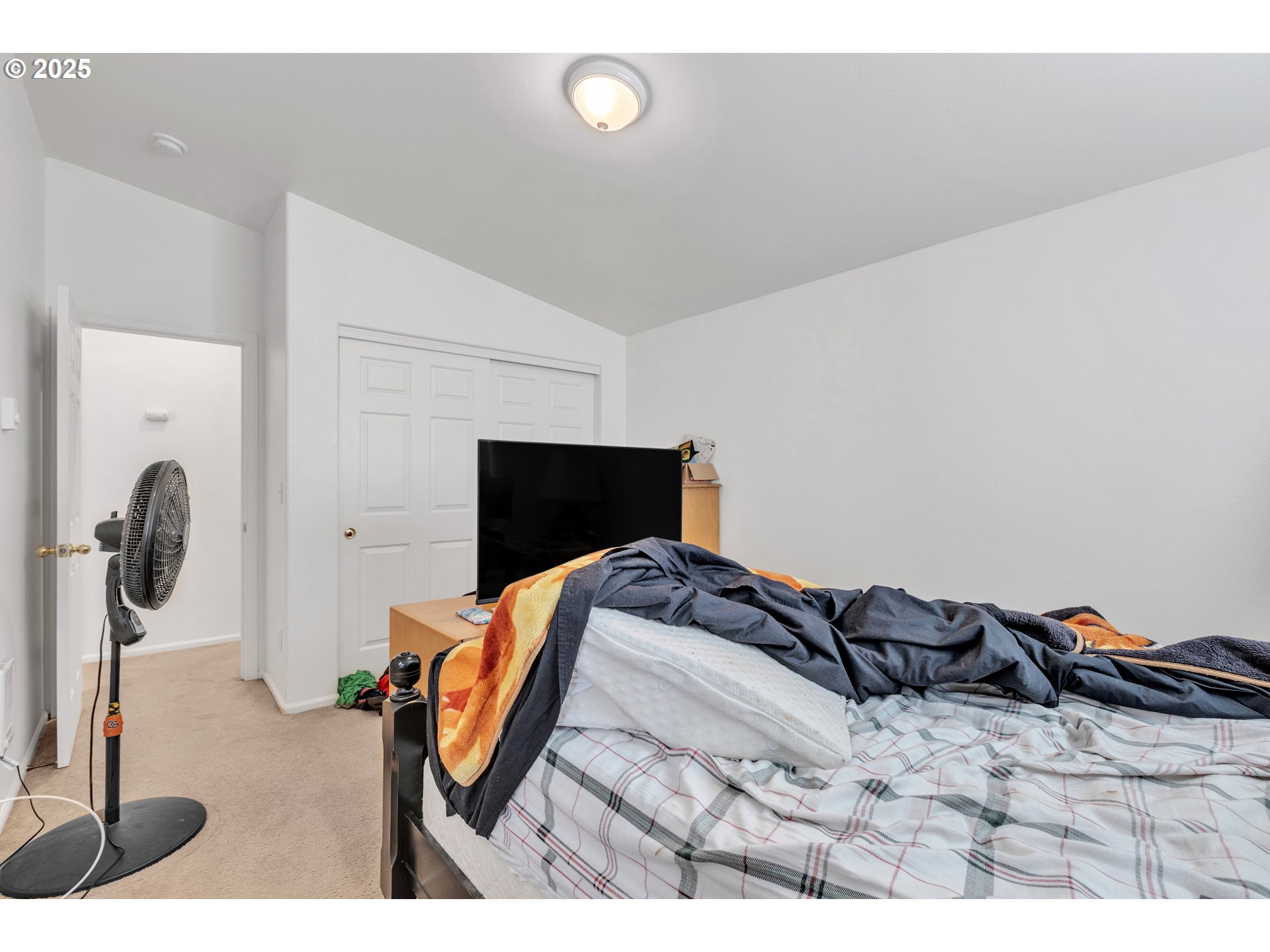 3397 Oak Street Florence, OR 97439 - Photo 14 of 48 a bedroom with a bed and tv