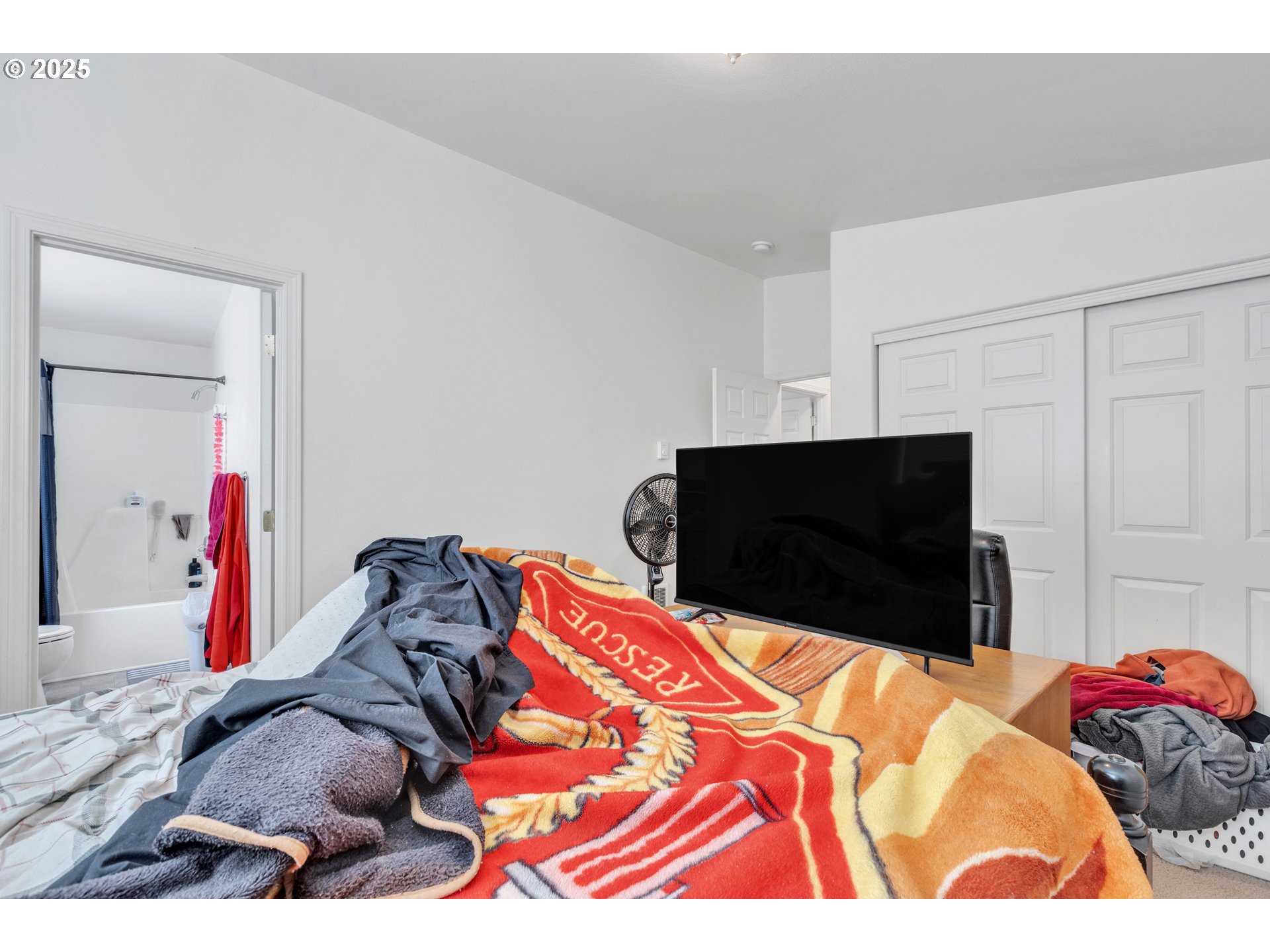 3397 Oak Street Florence, OR 97439 - Photo 15 of 48 a bedroom with a bed and a television