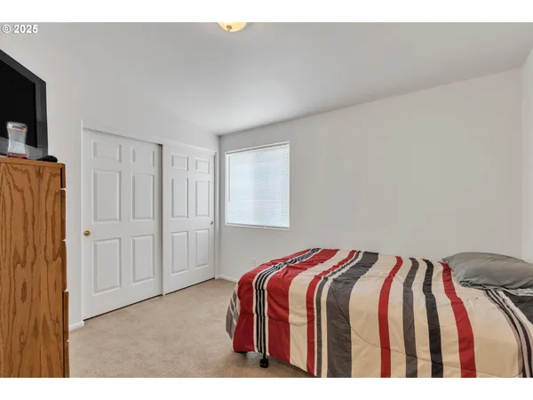 a bedroom with a bed and a tv