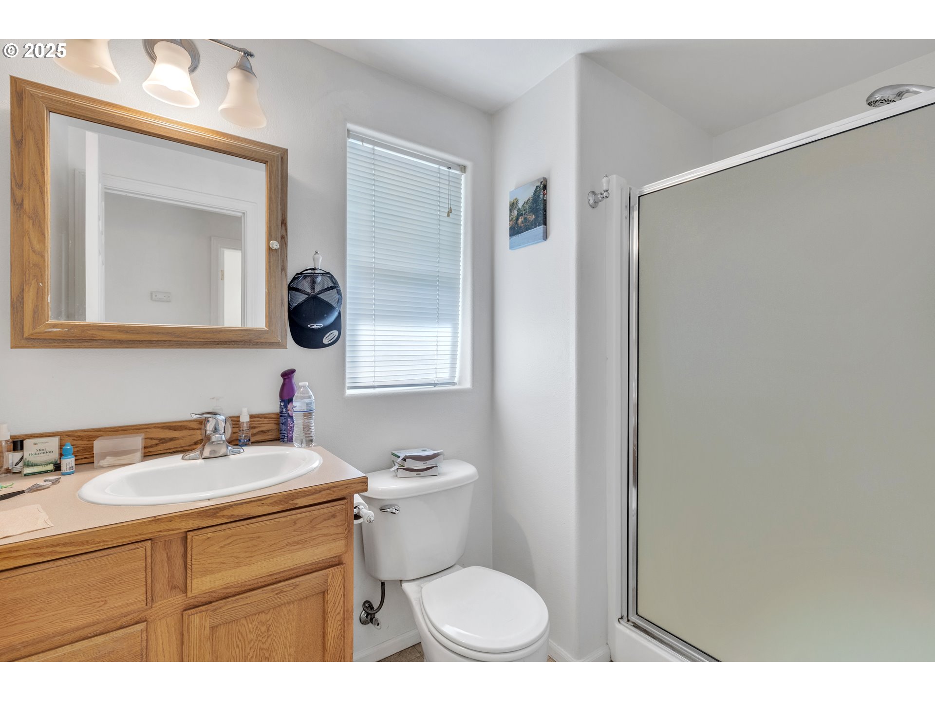 3397 Oak Street Florence, OR 97439 - Photo 20 of 48 a bathroom with a toilet sink vanity and mirror