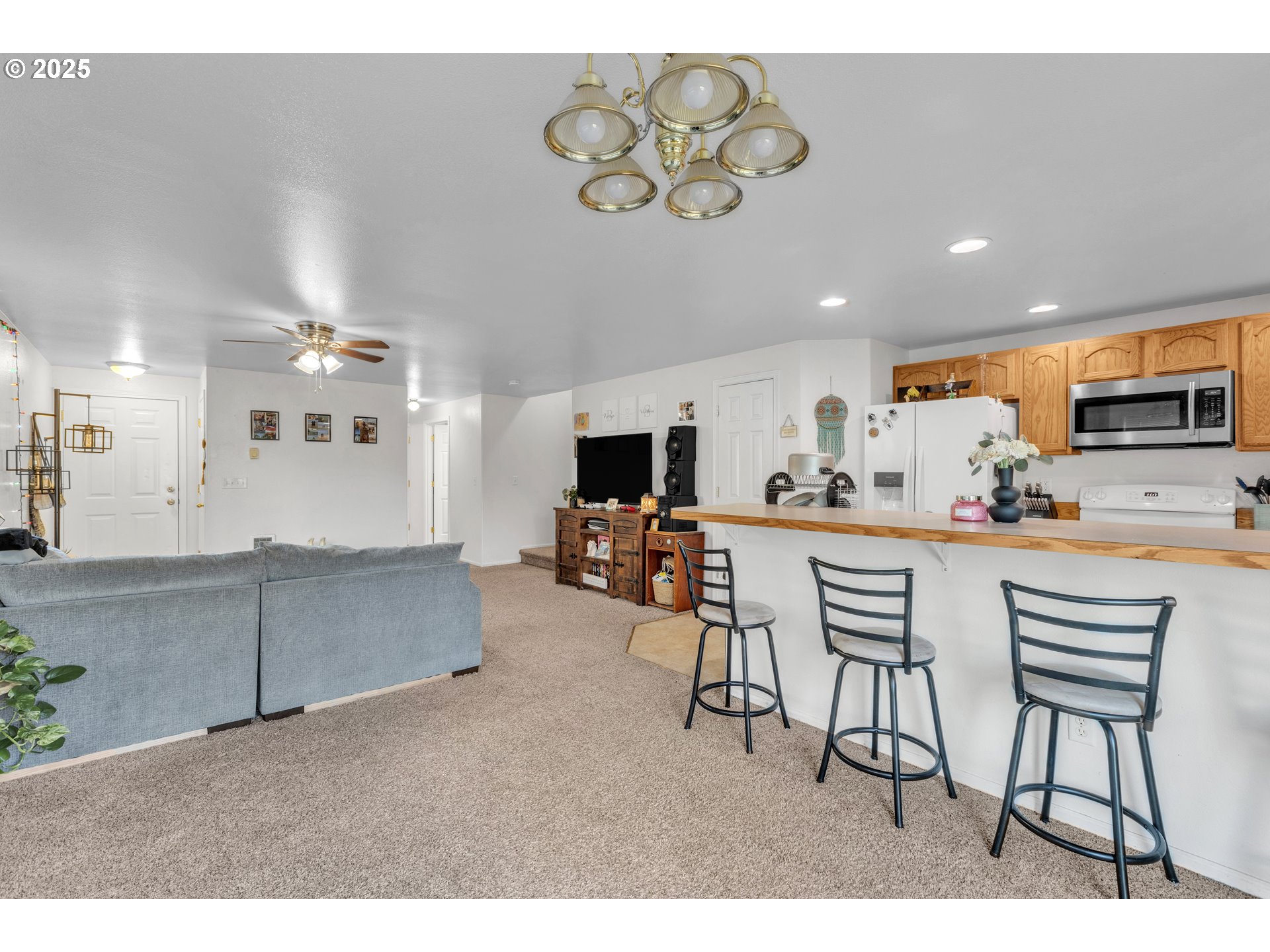 3397 Oak Street Florence, OR 97439 - Photo 28 of 48 a kitchen with stainless steel appliances kitchen island granite countertop a dining table chairs sink and cabinets