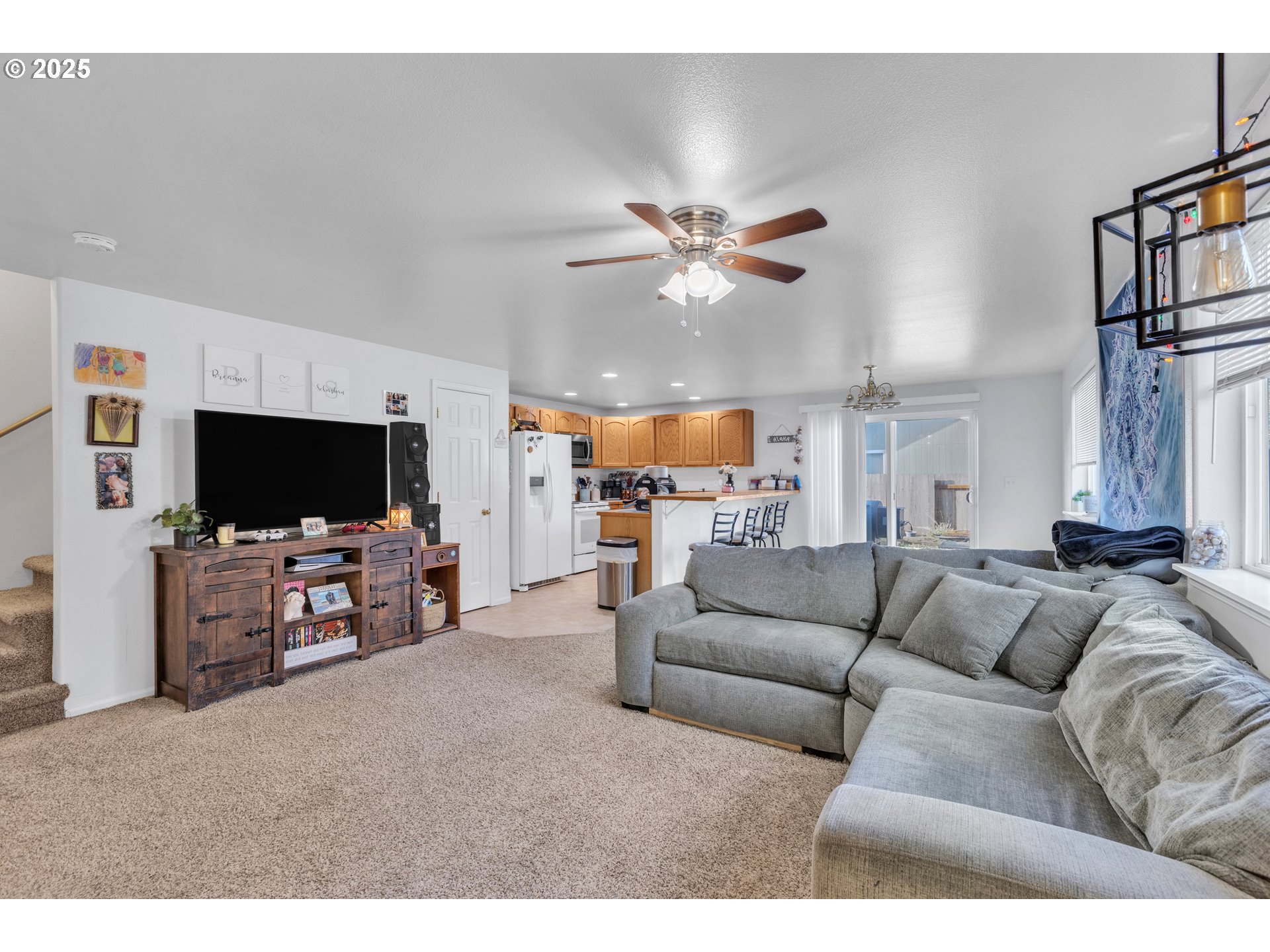 3397 Oak Street Florence, OR 97439 - Photo 30 of 48 a living room with furniture and a flat screen tv