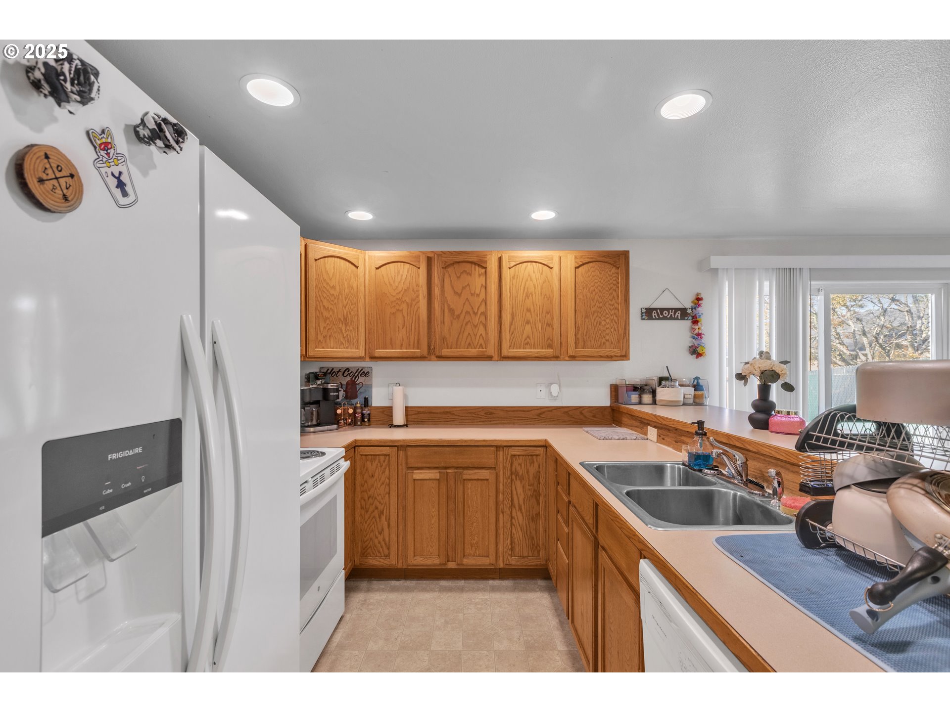 3397 Oak Street Florence, OR 97439 - Photo 34 of 48 a kitchen with a sink a stove a refrigerator and cabinets