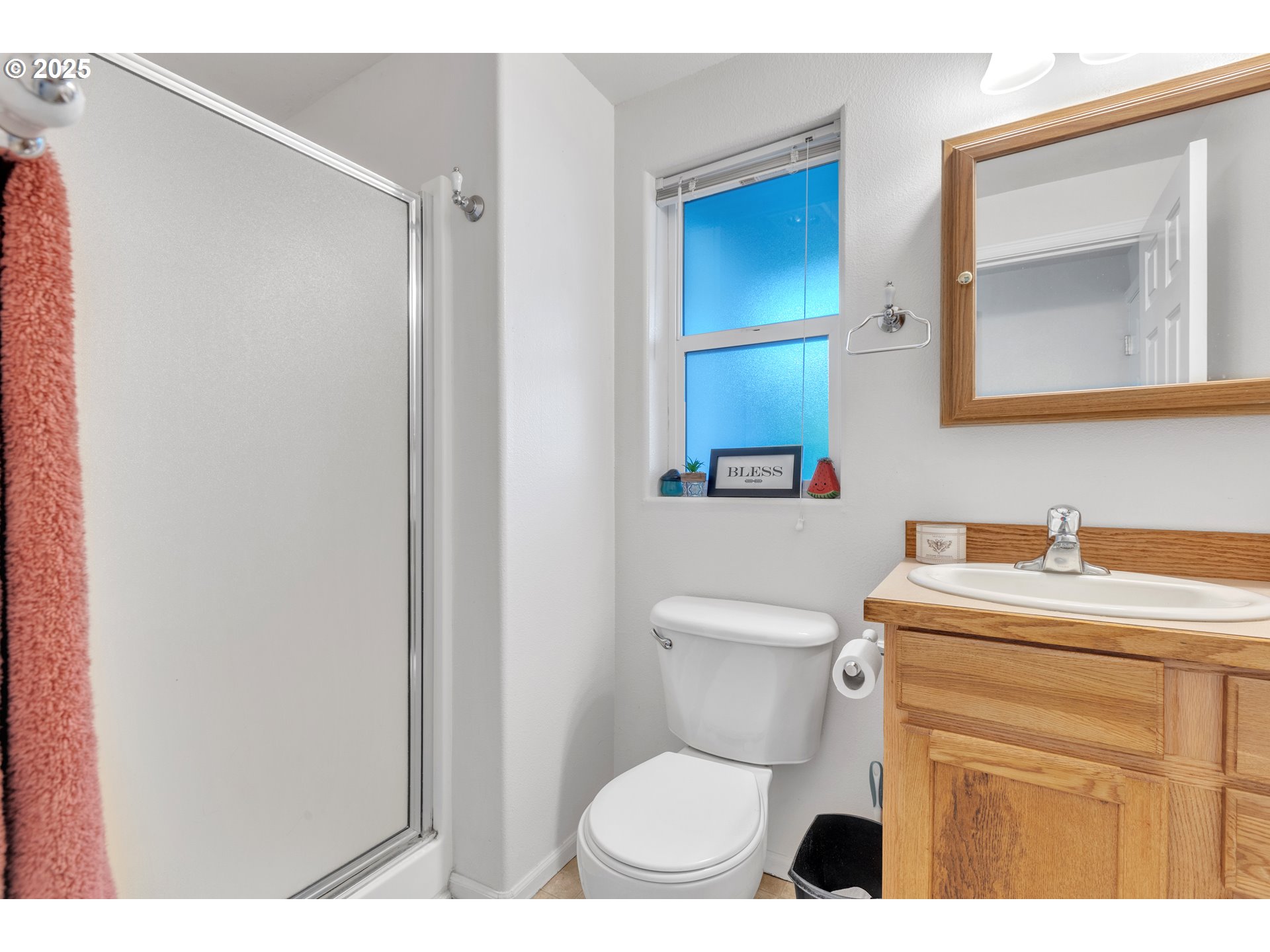 3397 Oak Street Florence, OR 97439 - Photo 43 of 48 a bathroom with a toilet sink vanity and mirror