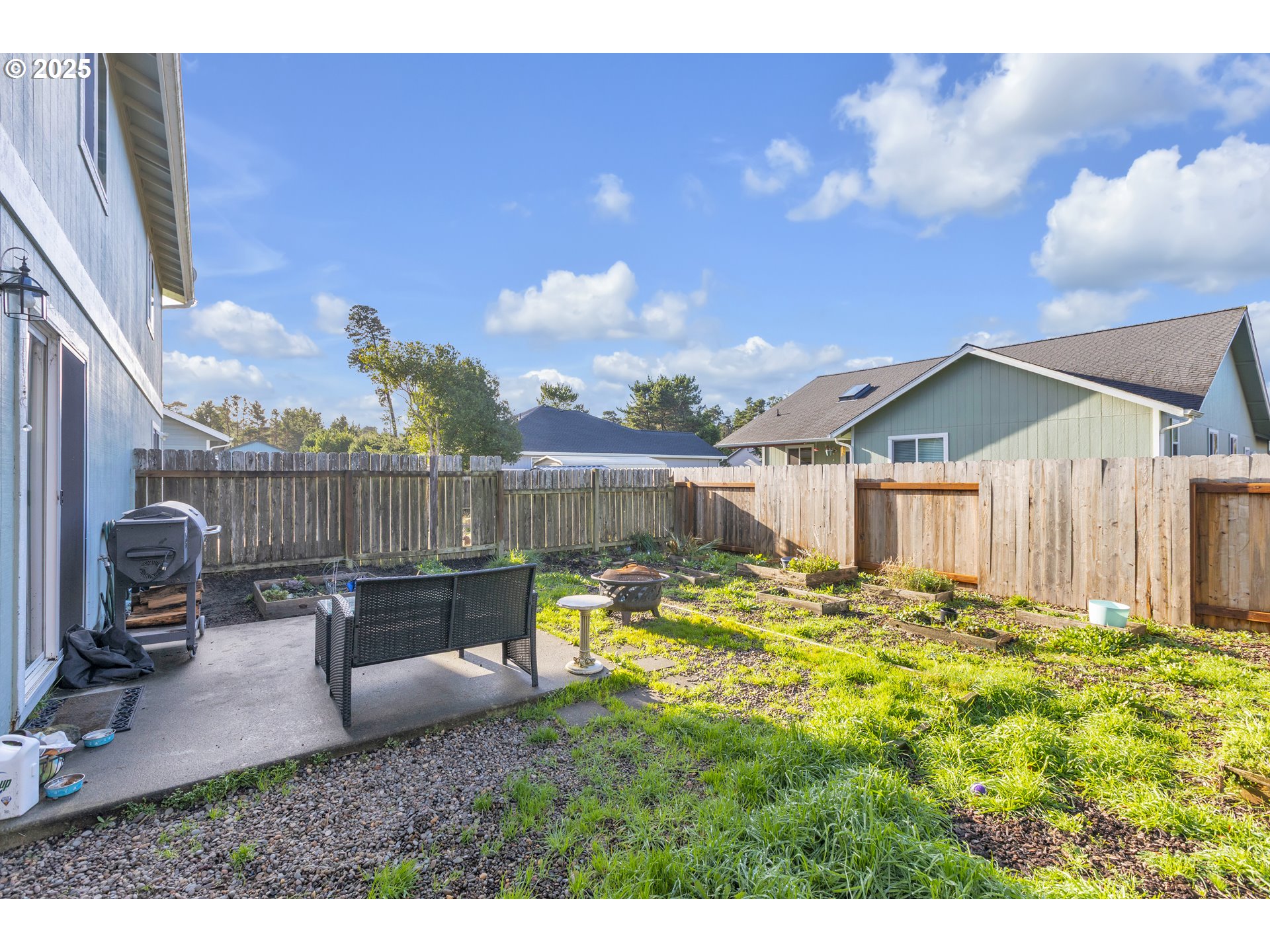 3397 Oak Street Florence, OR 97439 - Photo 46 of 48 a backyard of a house with table and chairs