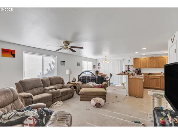 a living room with furniture and kitchen view