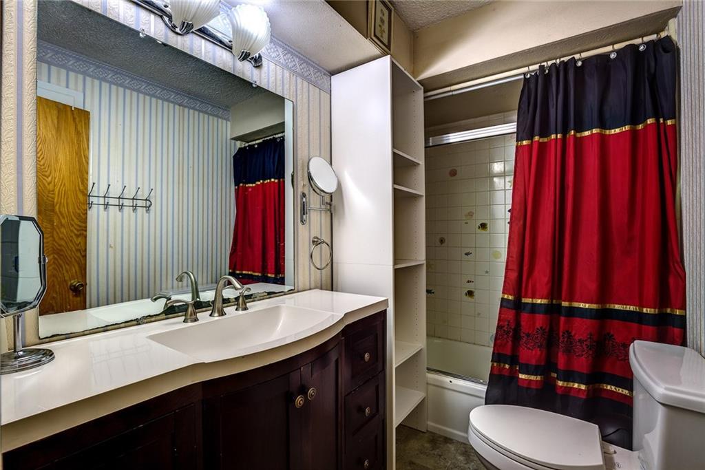 5627 Horizon Road Rockwall, TX 75032 - Photo 18 of 23 a bathroom with a sink a toilet and shower